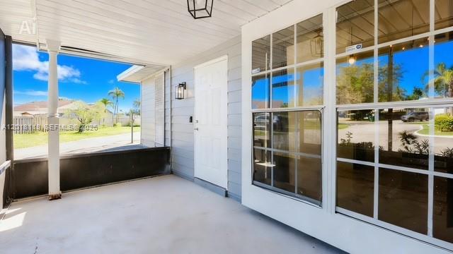 A covered patio with a white door, screened walls, and a view of the neighborhood — 1792 SW 84th Ave, Miramar FL 33027, MIRAMAR, FL