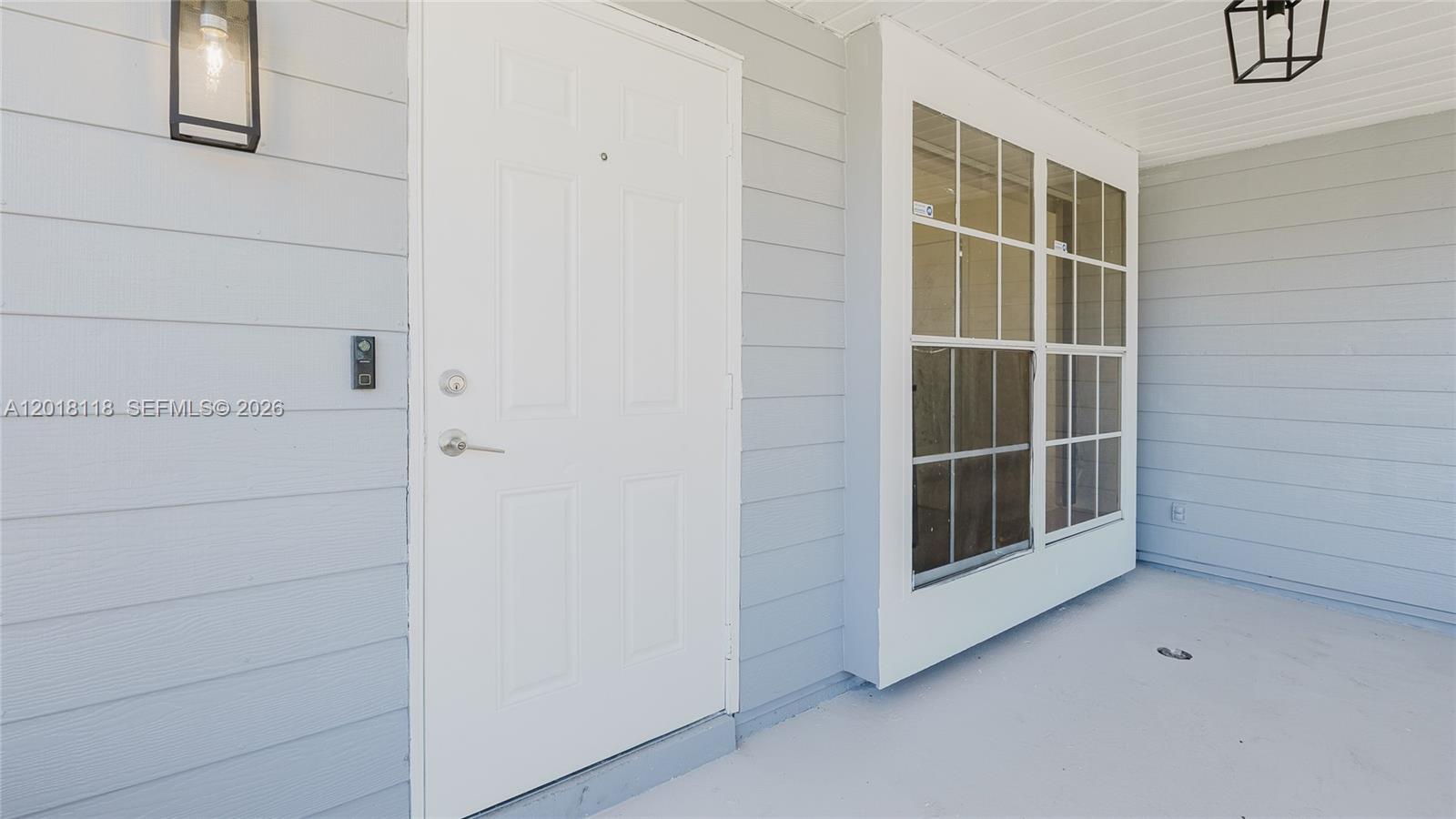 A white front door and a large window are set into a light gray exterior wall — 1792 SW 84th Ave, Miramar FL 33027, MIRAMAR, FL