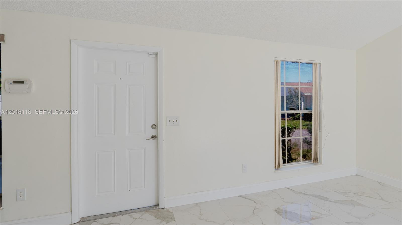 A room with white walls, a white front door, and light-colored marble-style tile flooring — 1792 SW 84th Ave, Miramar FL 33027, MIRAMAR, FL