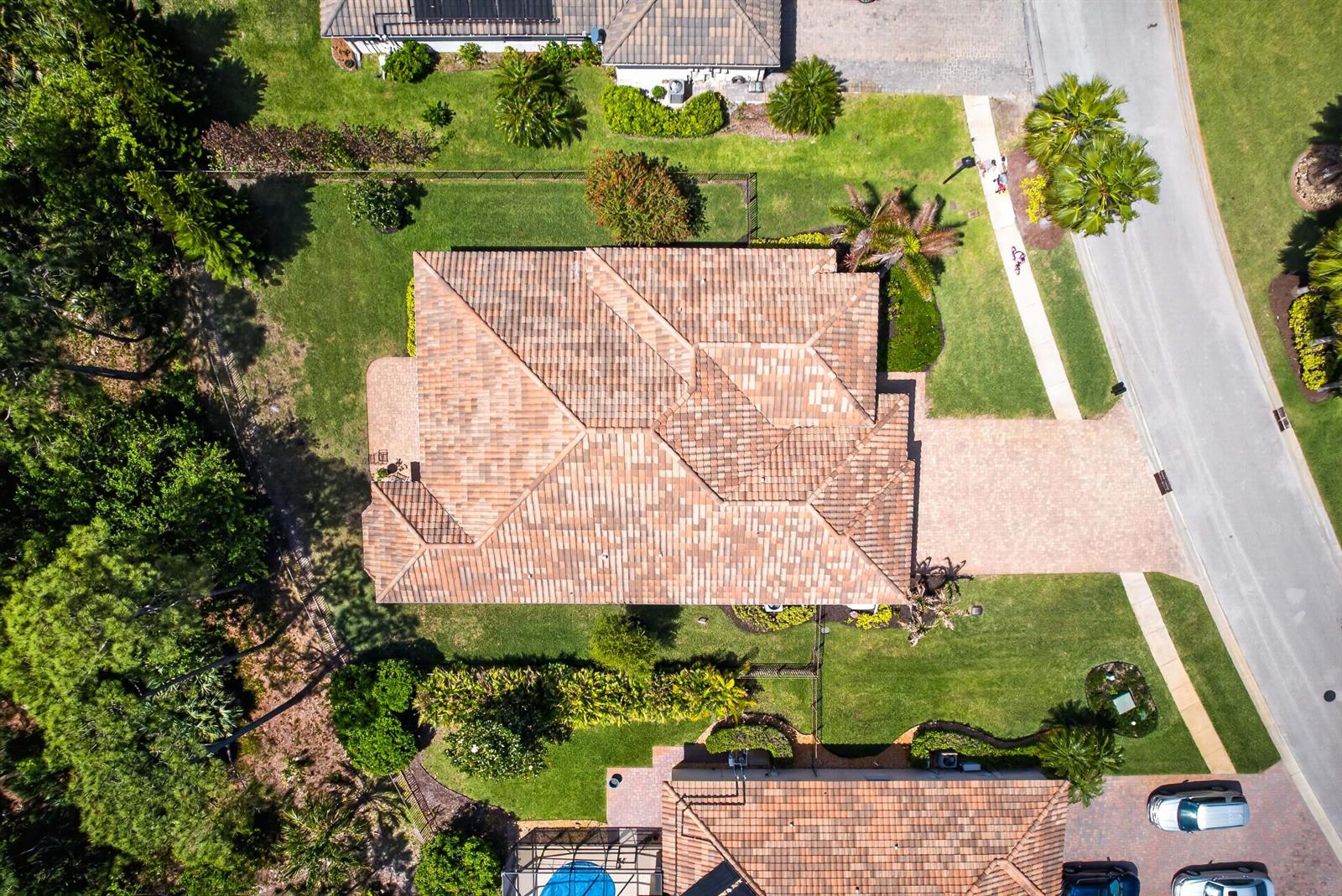 An aerial view of a residential house with a tiled roof and a paved driveway — 7589 Fieldstone Ranch Square, Vero Beach FL 32967, VERO BEACH, FL