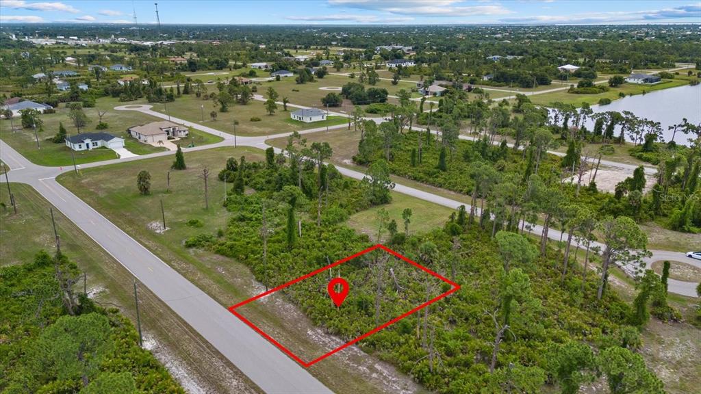 An aerial view shows a vacant, rectangular lot outlined in red along a paved road — 49 MASTHEAD ROAD, PLACIDA, FL