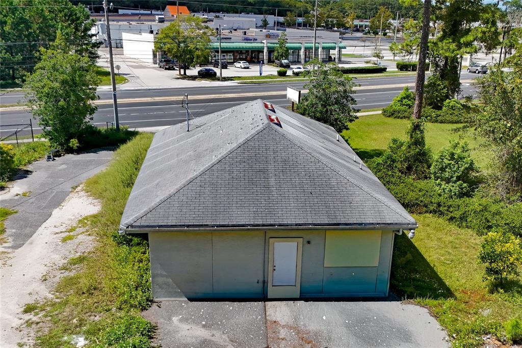 An aerial view of a small, single-story building with a gray shingled roof — 11127 LEM TURNER ROAD, JACKSONVILLE, FL
