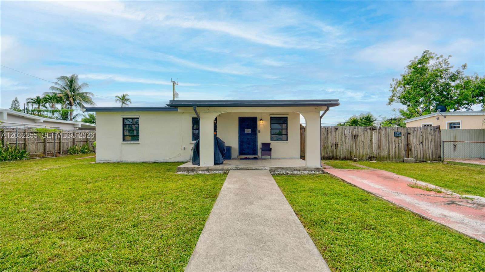 A single-story house with a covered front porch, concrete walkway, and a fenced yard — 9840 SW 48th St, Miami FL 33165, MIAMI, FL