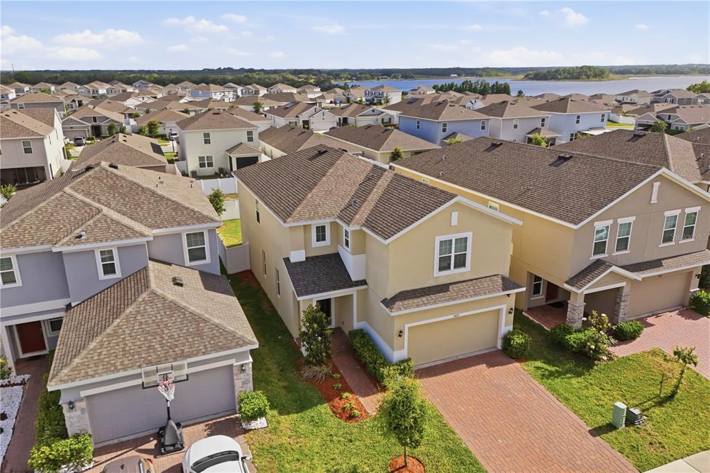 An aerial view shows suburban houses with brown shingled roofs and paved driveways — 6825 WILSON HAMMOCK AVENUE, GROVELAND, FL