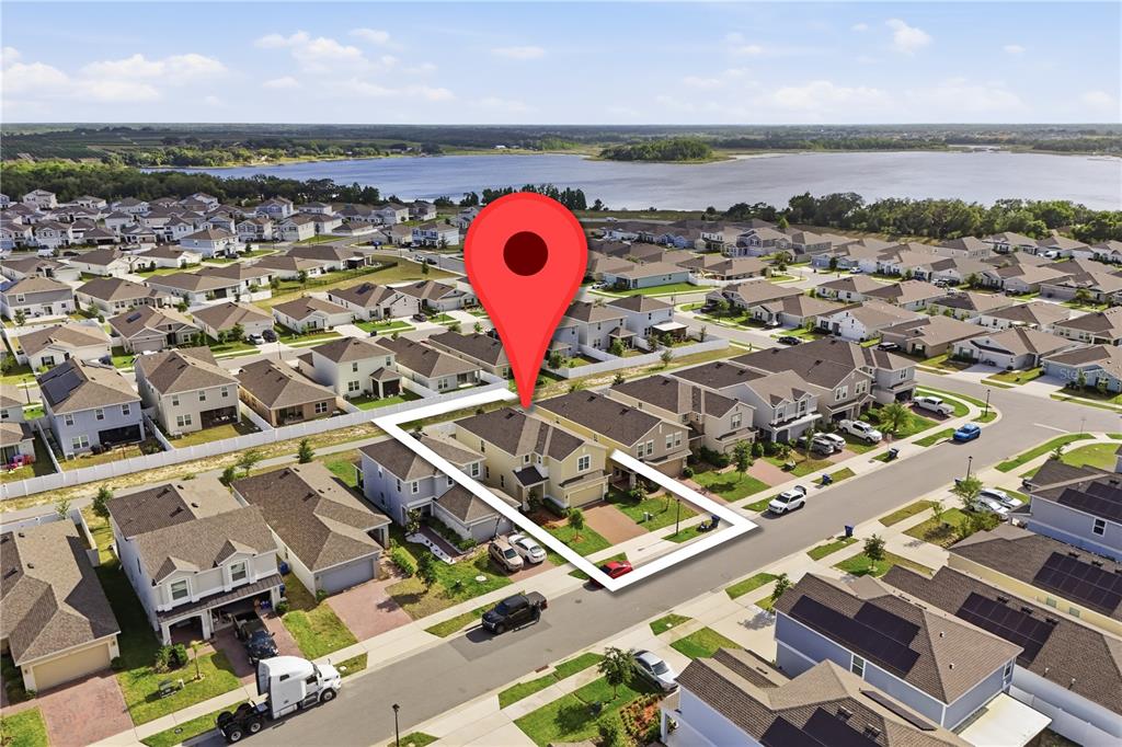 An aerial view shows a suburban house with a red map pin marker — 6825 WILSON HAMMOCK AVENUE, GROVELAND, FL