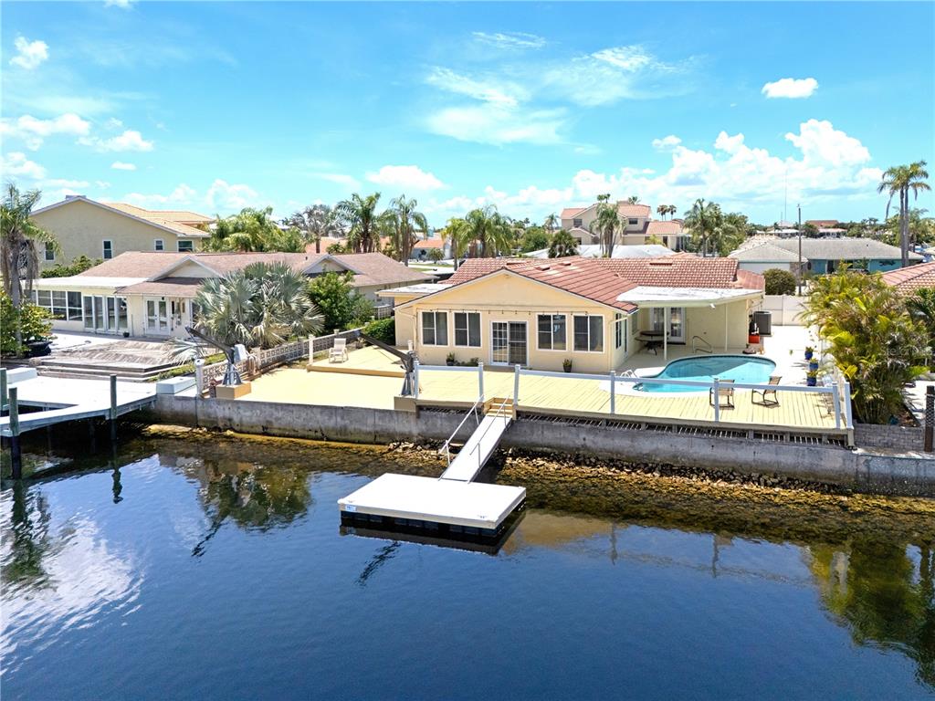 An aerial view of a waterfront house with a pool, deck, and private boat dock — 3517 SEAWAY DRIVE, NEW PORT RICHEY, FL