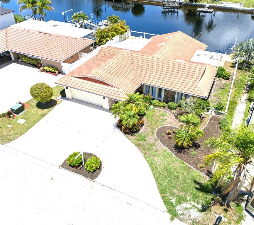 An aerial view shows a single-story house with a tile roof and a concrete driveway — 3517 SEAWAY DRIVE, NEW PORT RICHEY, FL