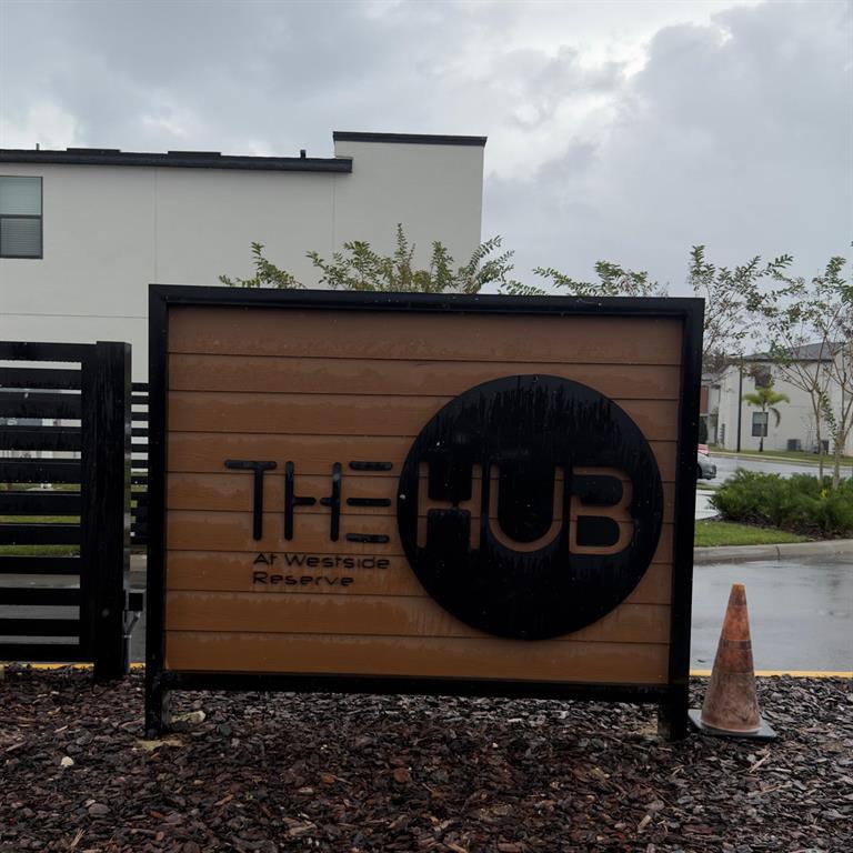 A sign for The Hub at Westside Reserve stands outdoors in front of a building — 3229 ENERGY DRIVE, KISSIMMEE, FL