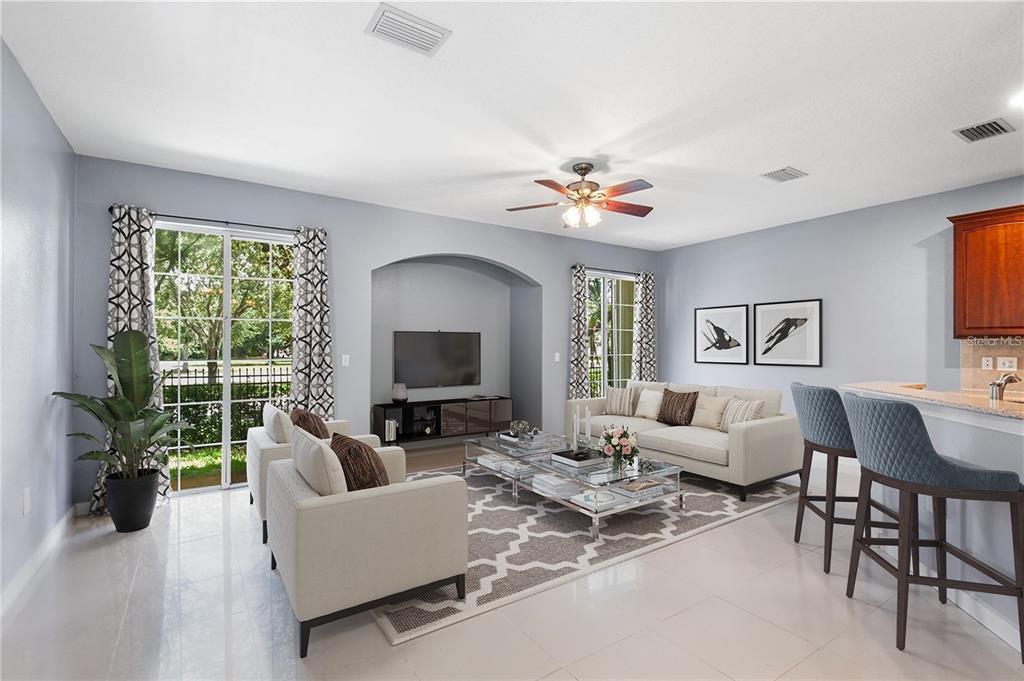 A living room with light gray walls, white tile floors, a ceiling fan, and furniture — 6745 BREEZY PALM DRIVE, RIVERVIEW, FL