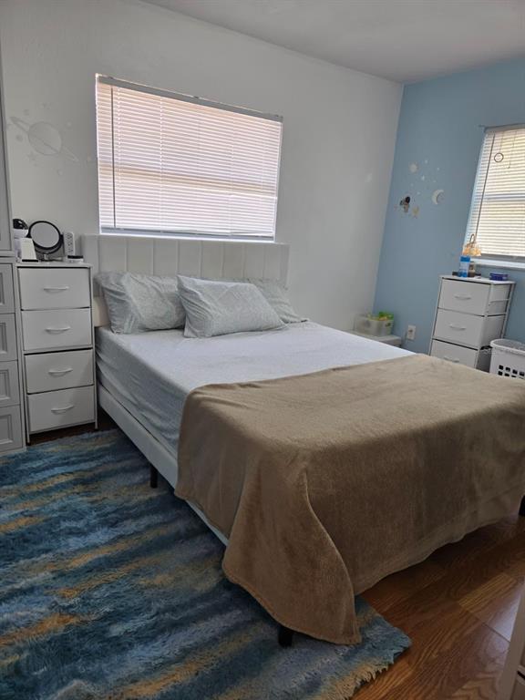 A bedroom features a bed with a white headboard, two white dressers, and a blue rug — 459 WATER ROAD, OCALA, FL