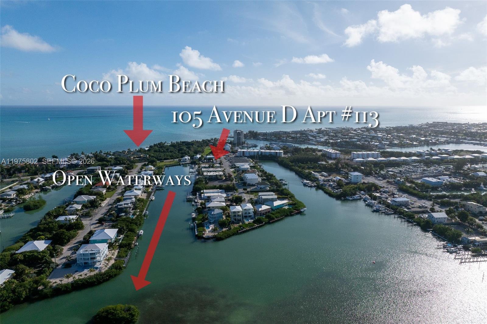 An aerial view shows a coastal residential area with houses situated along narrow waterways — 105 Avenue D # 113, Marathon FL 33050, MARATHON, FL