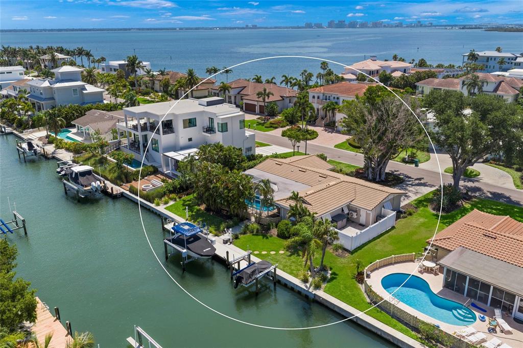 An aerial view of a waterfront house with a pool, boat dock, and canal access — 549 HALYARD LANE, LONGBOAT KEY, FL