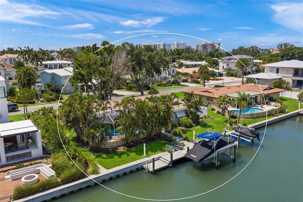 An aerial view of a waterfront house with a pool, dock, and boat lift — 549 HALYARD LANE, LONGBOAT KEY, FL