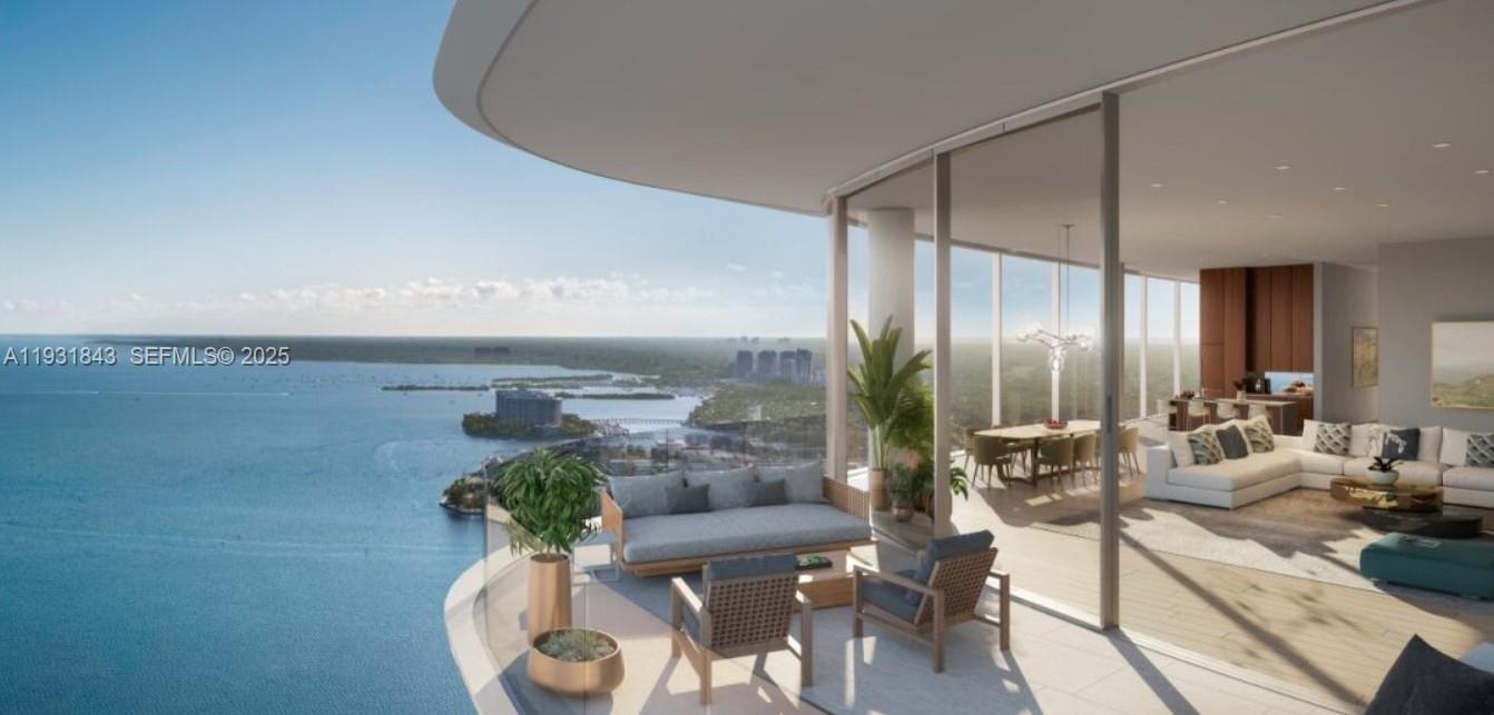 This architectural rendering shows a luxury high-rise balcony overlooking a bay and coastal landscape — 175 SE 25th Rd # 4201, Miami FL 33129, MIAMI, FL