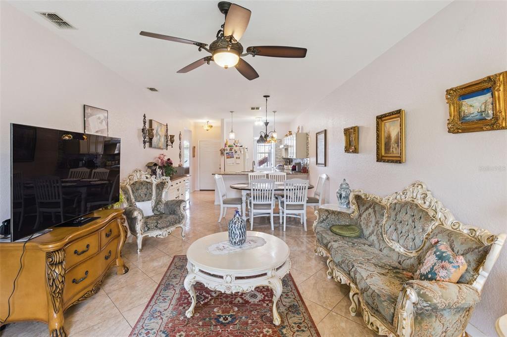 A living room and dining area with ornate furniture, tile floors, and a ceiling fan — 5101 LAKE MARION GOLF RESORT UNIT 5101, KISSIMMEE, FL