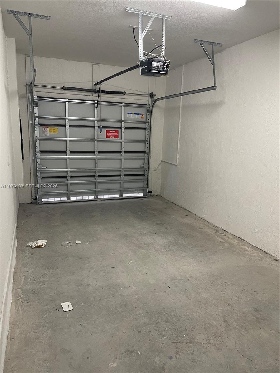 A standard residential garage with a concrete floor and an overhead sectional door — 20564 NE 5th Pl, Miami FL 33179, MIAMI, FL