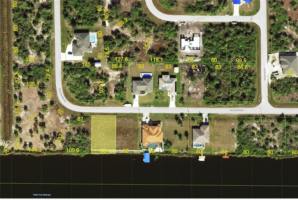 This is an aerial map showing residential lots along a waterway and a curved road — 13421 GREENCASTLE AVENUE, PORT CHARLOTTE, FL