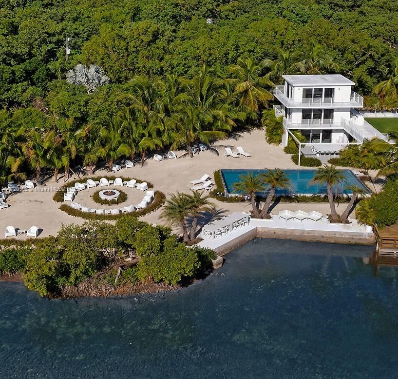 An aerial view shows a multi-story white house, a swimming pool, and a circular seating area — 98701 Overseas Hwy, Key Largo FL 33037, KEY LARGO, FL