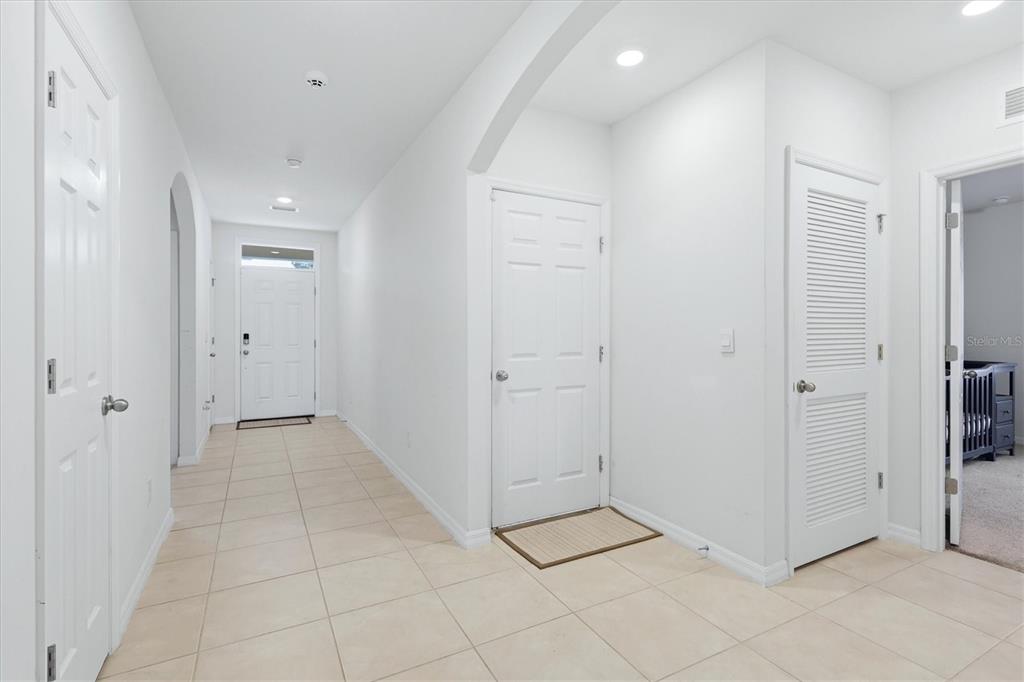 A bright entryway features white walls, tiled flooring, multiple interior doors, and a front door — 258 RIO DE JANEIRO AVENUE, PUNTA GORDA, FL