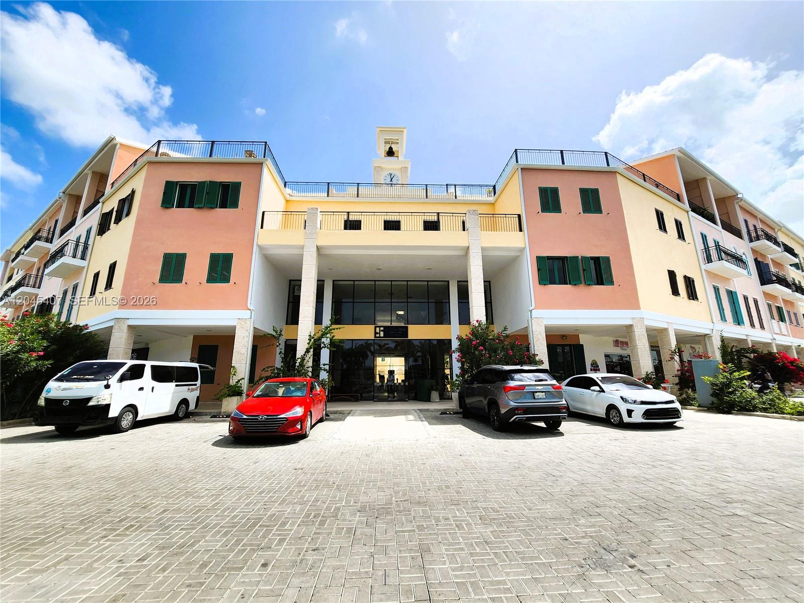 A multi-story building with a clock tower and a paved parking lot in front — D.R. AVENIDA ALEMANIA # 2, DR, DR