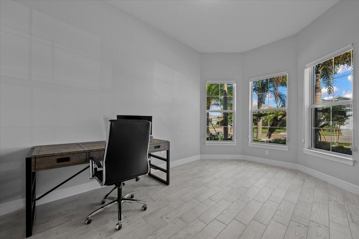 A home office features light gray tile flooring, a desk, and a bay window — 10366 Northbrook Circle, Palm Beach Gardens FL 33412, PALM BEACH GARDENS, FL