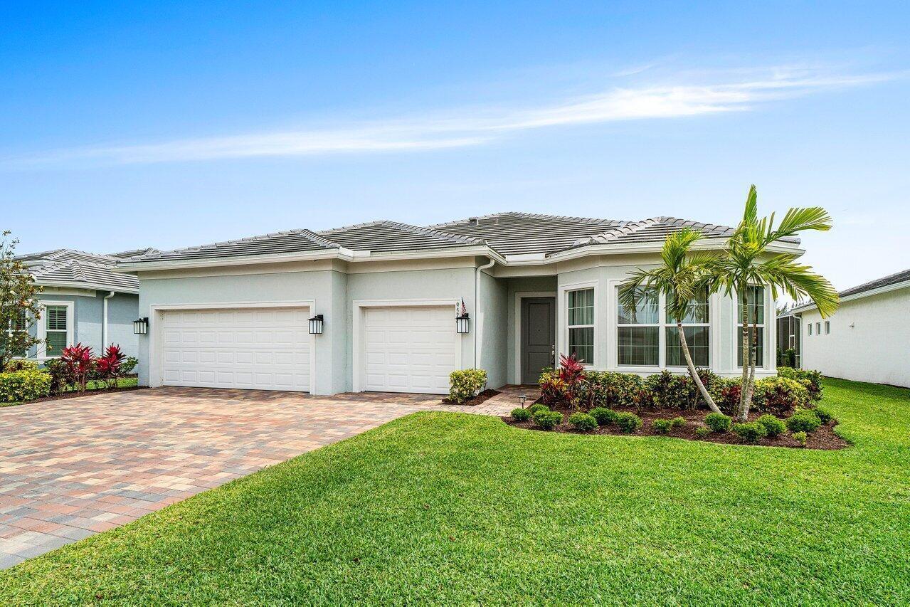 A single-story house with a two-car garage, gray roof, and a landscaped front yard — 9578 Mosler Trail, Lake Worth FL 33467, LAKE WORTH, FL