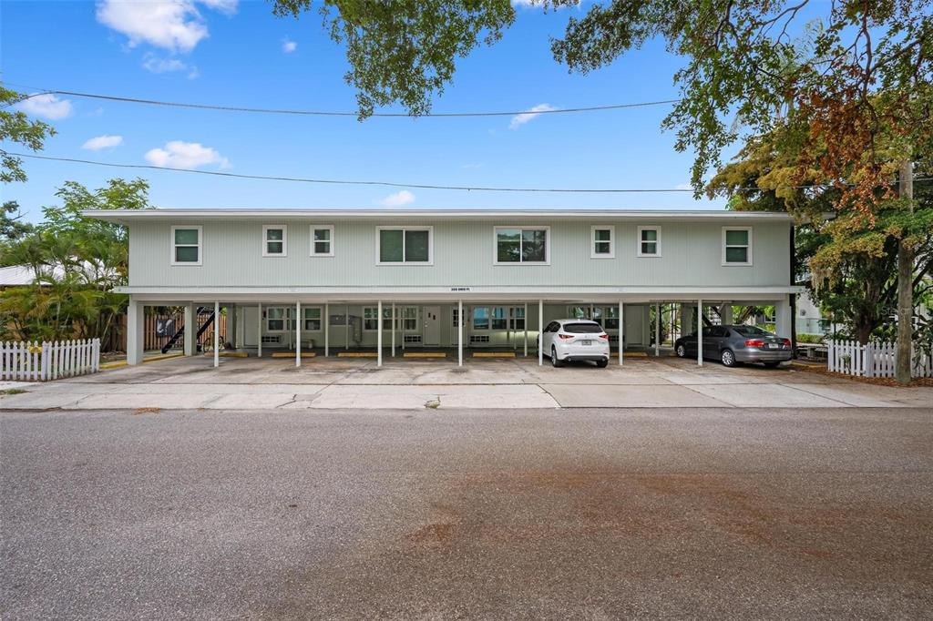 A two-story apartment building with ground-level covered parking and a light green exterior — 308 OHIO PLACE UNIT 2, SARASOTA, FL