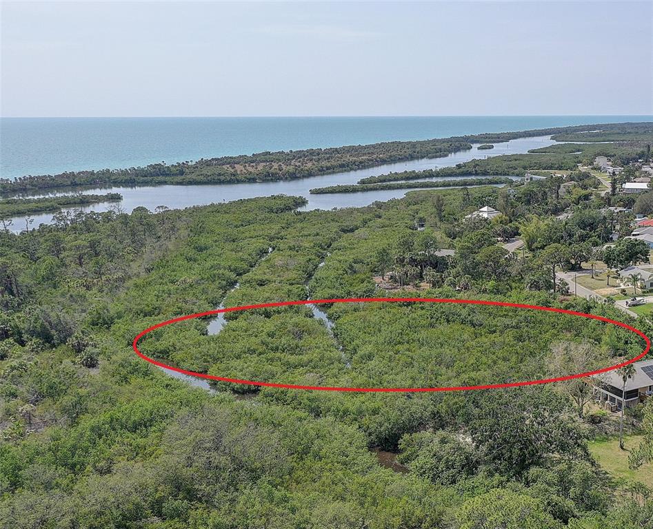 An aerial view shows a dense mangrove forest with a red oval highlighting a section — 0 LEMON BAY DRIVE, VENICE, FL