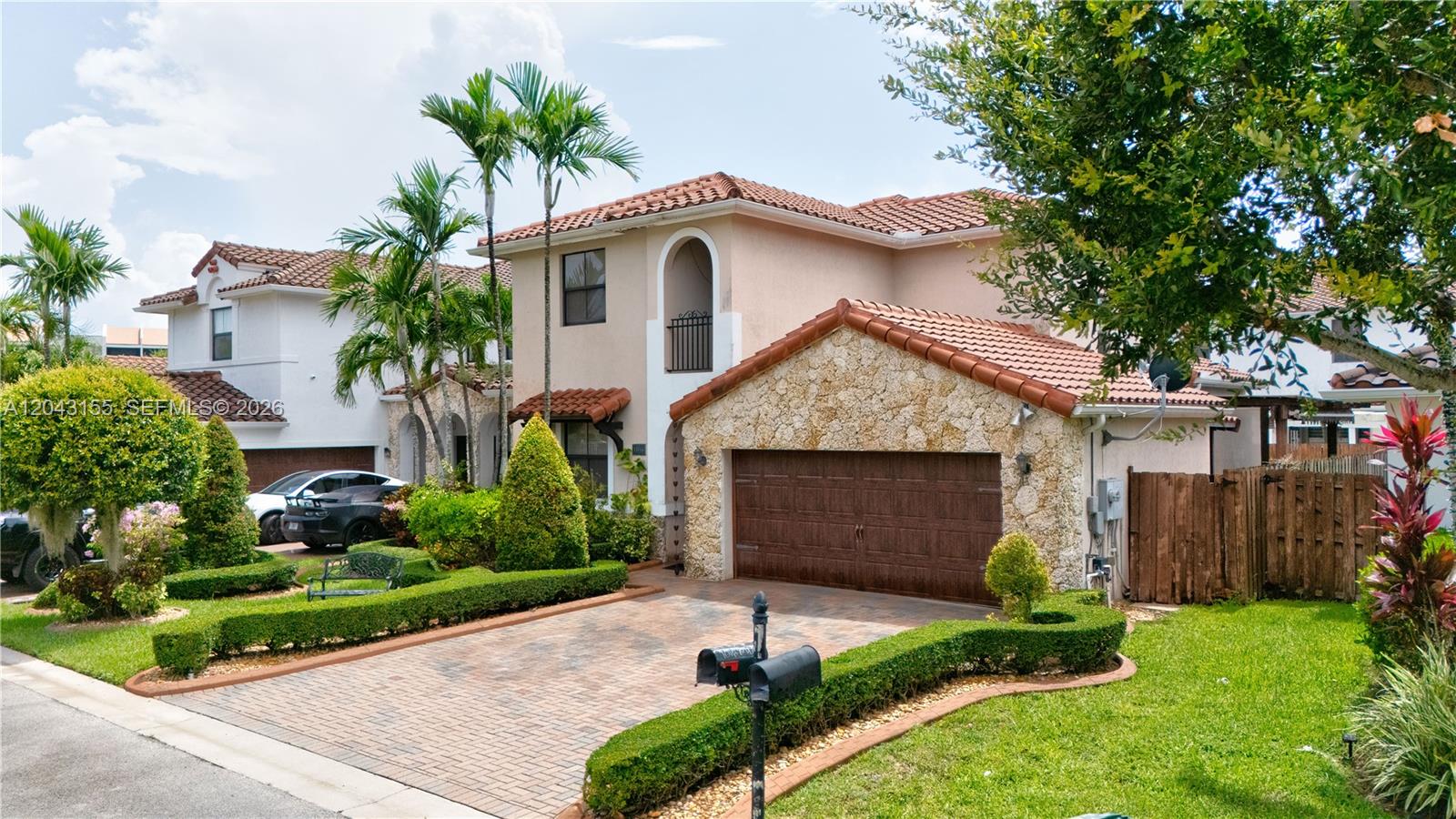 A two-story house with a stone-faced garage, tile roof, and landscaped front yard — 1016 NW 99th Psge # 1016, Miami FL 33172, MIAMI, FL