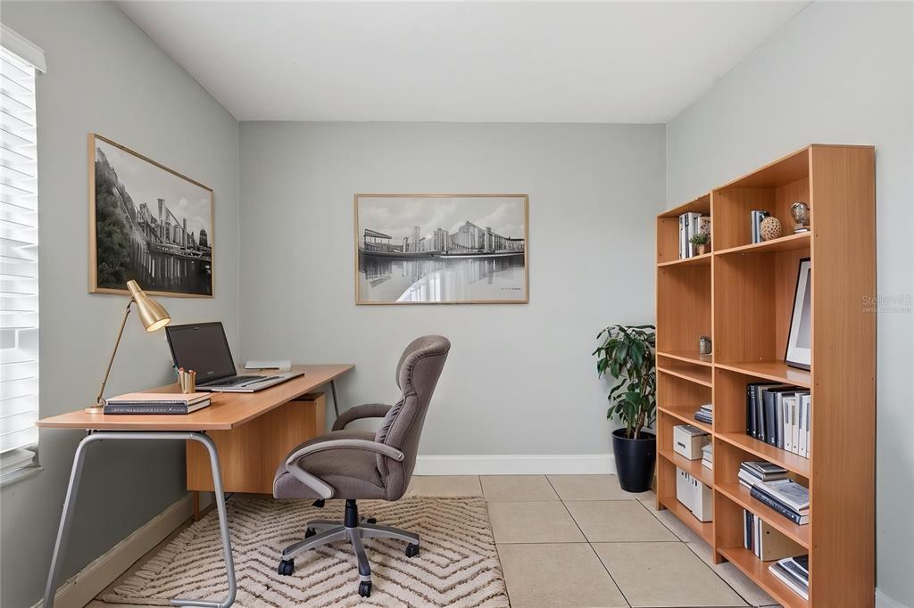 A home office features a wooden desk, an office chair, a bookshelf, and two wall pictures — 2762 MYAKKA DRIVE, ORLANDO, FL
