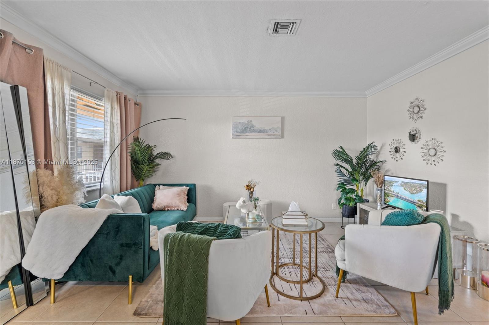 A living room features a green velvet sofa, two white armchairs, and a glass coffee table — 200 Croton Ave # 111, Lantana FL 33462, LANTANA, FL