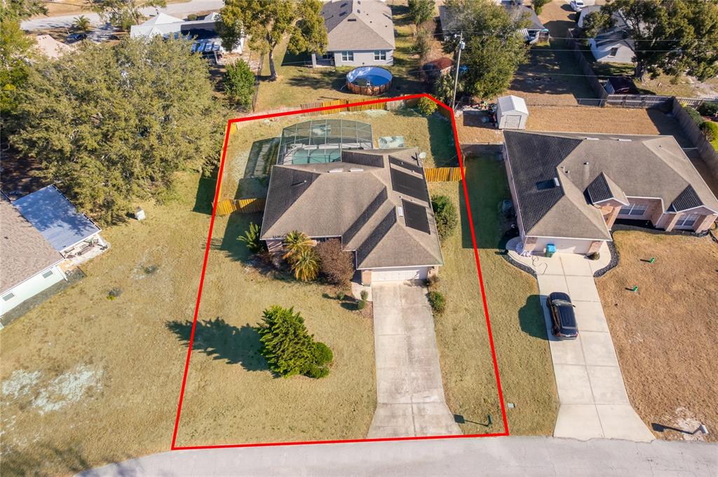 An aerial view shows a single-story house with a pool enclosure and a concrete driveway — 794 SELBY STREET, DELTONA, FL