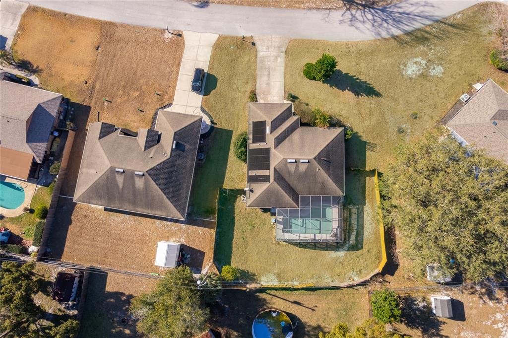 An aerial view shows two suburban houses with swimming pools and driveways on a residential street — 794 SELBY STREET, DELTONA, FL
