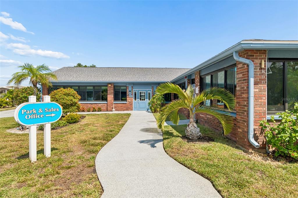A vacant, sandy lot sits between mobile homes under a bright, sunny sky — 9790 66TH STREET N UNIT 382, PINELLAS PARK, FL