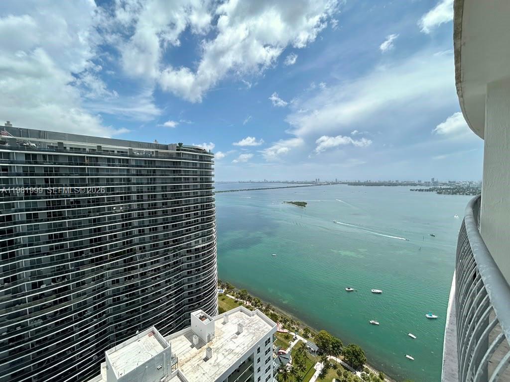 A high-angle view shows a large residential tower overlooking a bay with boats — 1750 N Bayshore Dr # 5307, Miami FL 33132, MIAMI, FL