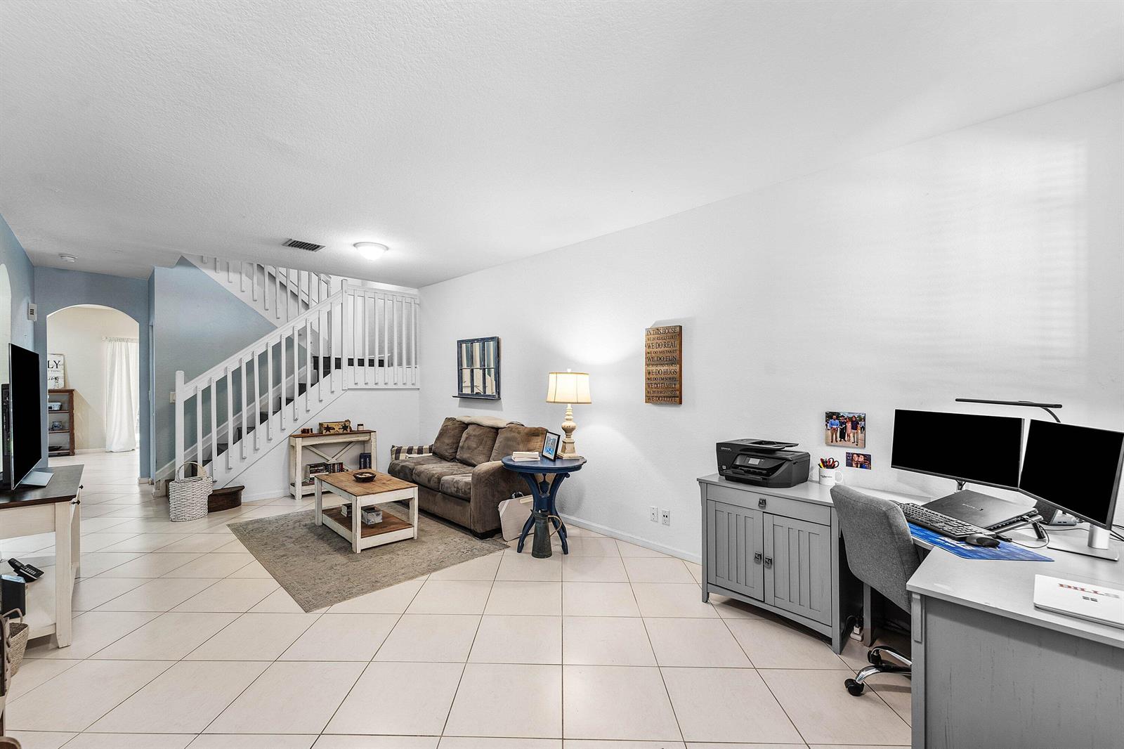 A living room features a staircase, a brown sofa, a coffee table, and a home office — 331 Spruce Street, Boynton Beach FL 33426, BOYNTON BEACH, FL