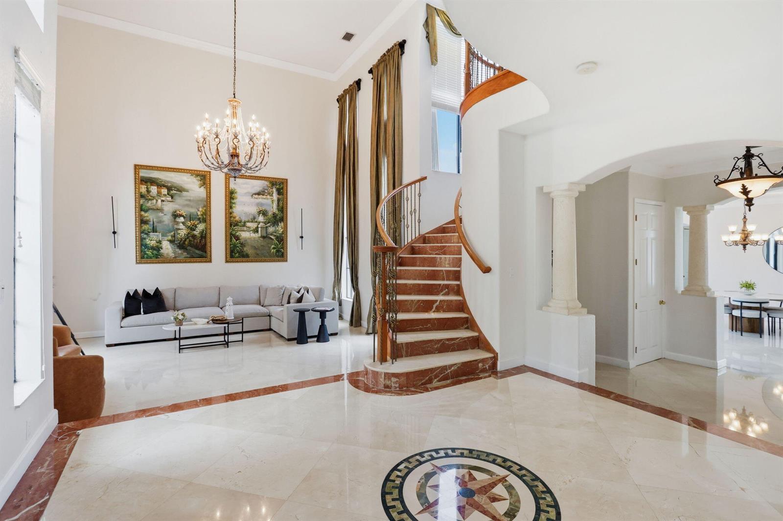 A grand foyer features a marble staircase, a compass medallion floor, and a living area — 18662 SW 17th Court, Miramar FL 33029, MIRAMAR, FL
