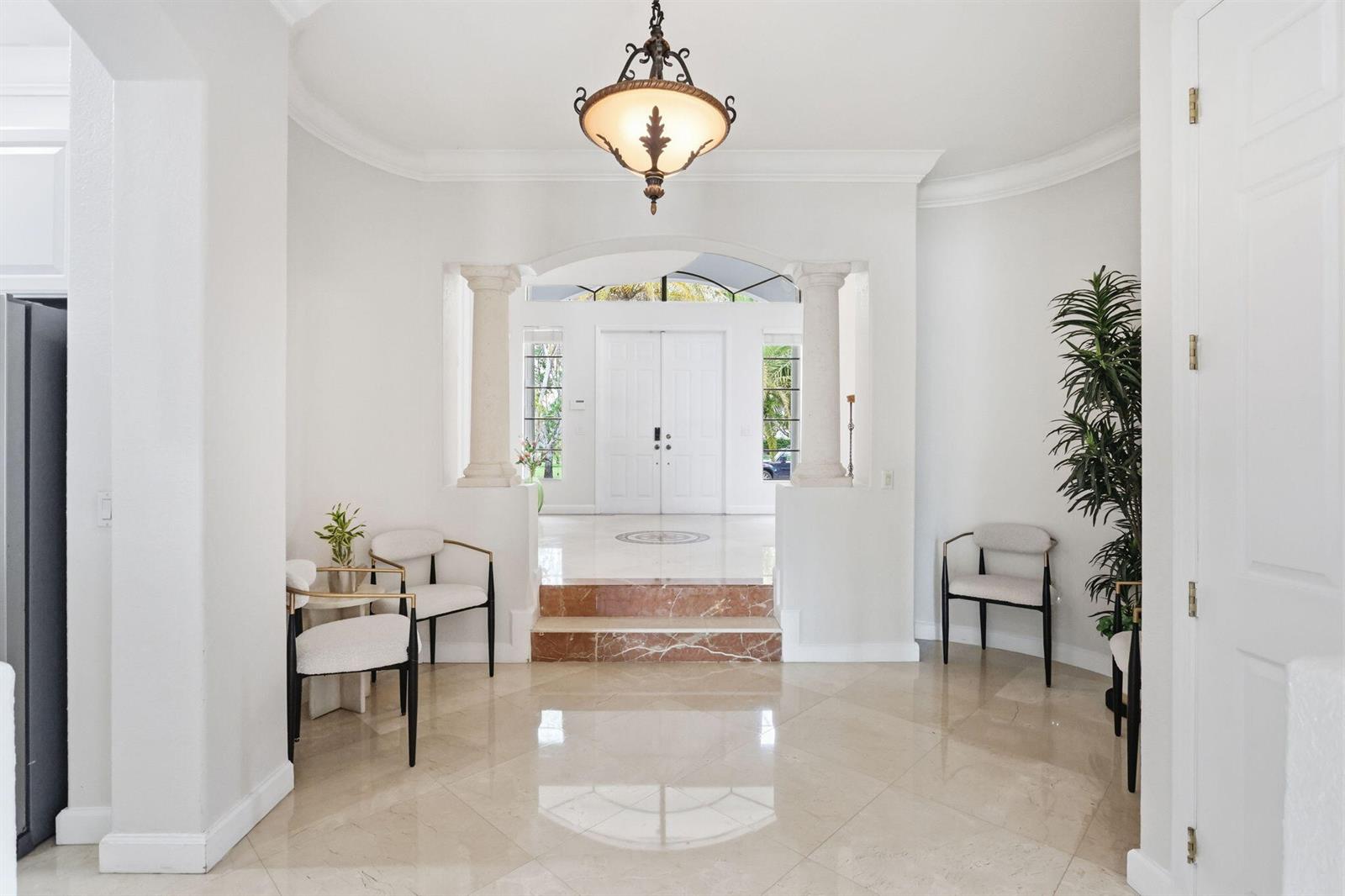 A bright foyer features marble floors, two white columns, and a step up to double doors — 18662 SW 17th Court, Miramar FL 33029, MIRAMAR, FL