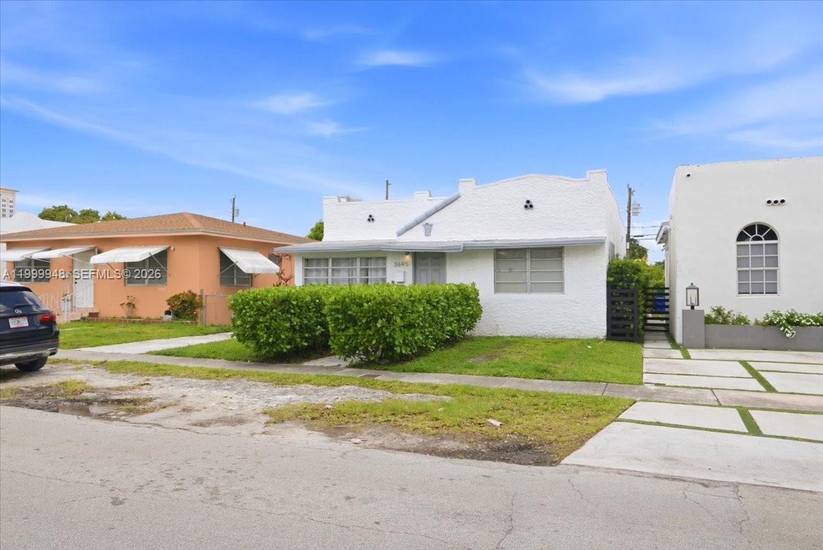 A white stucco house with a flat roof and a hedge stands between two neighbors — 3645 SW 25th Ter, Miami FL 33133, MIAMI, FL