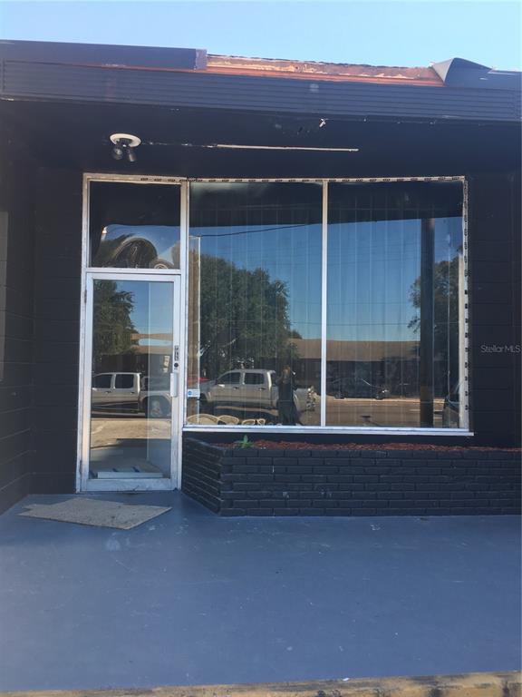 The exterior of a commercial building features a glass storefront with a single door — 629 N SEMORAN BOULEVARD, ORLANDO, FL