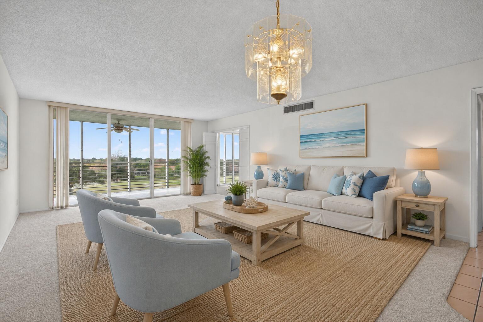 A bright living room features a white sofa, two light blue chairs, and a chandelier — 3507 Oaks Way # 501, Pompano Beach FL 33069, POMPANO BEACH, FL