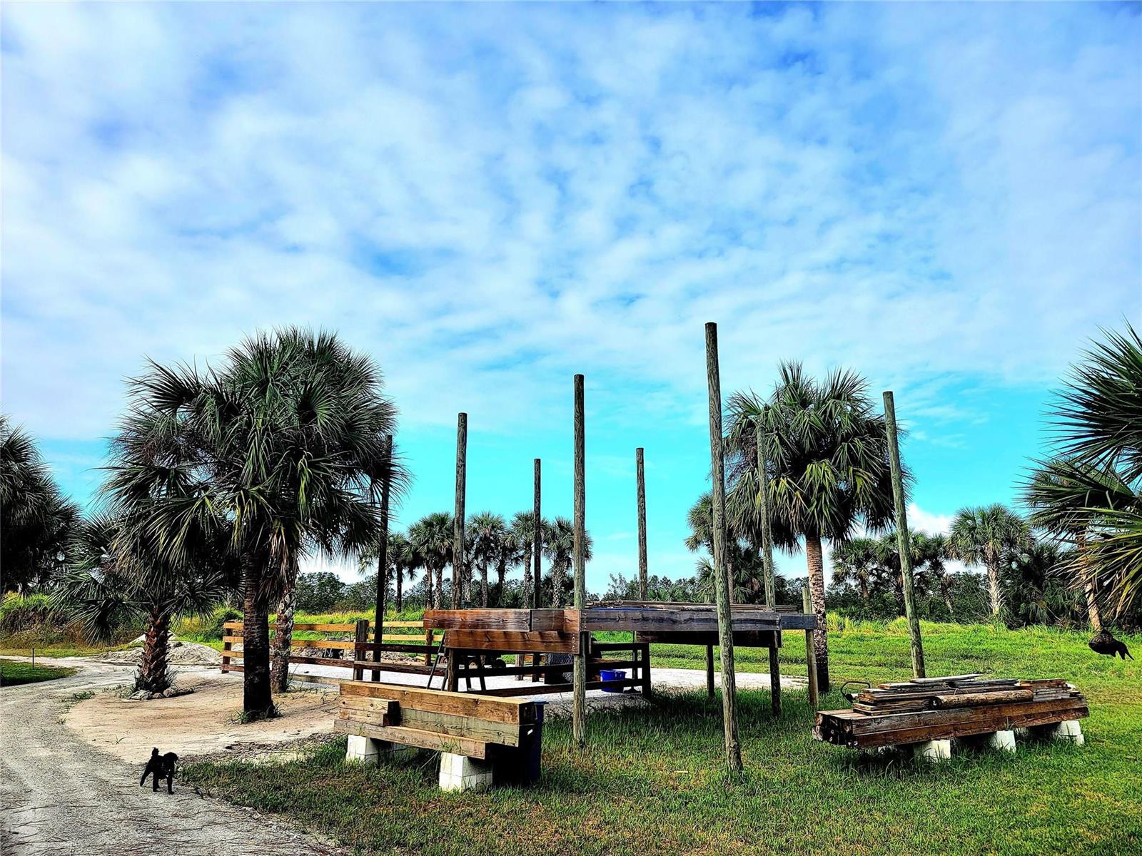A metal gate sits between wooden fence posts at the entrance to a dirt driveway — 15350 93rd Street, Fellsmere FL 32948, FELLSMERE, FL