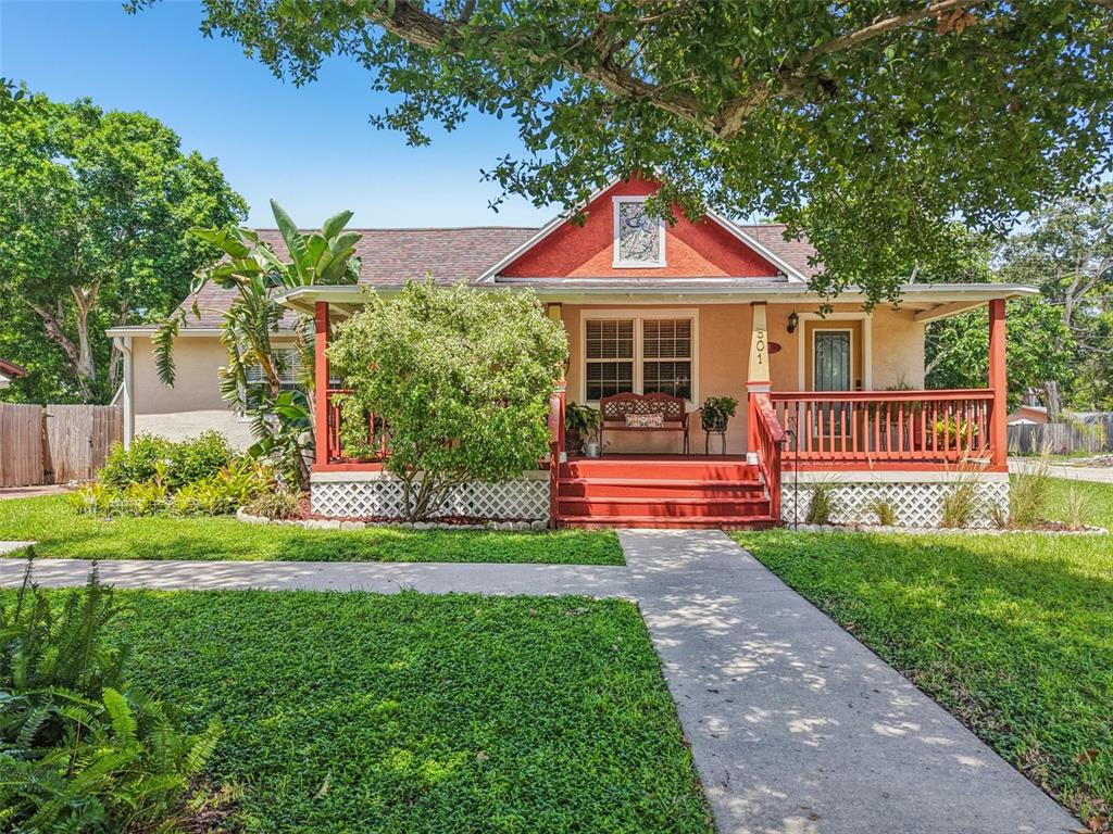 A one-story house with a red-trimmed porch, lattice skirting, and a front walkway — 501 32ND AVENUE N, ST PETERSBURG, FL