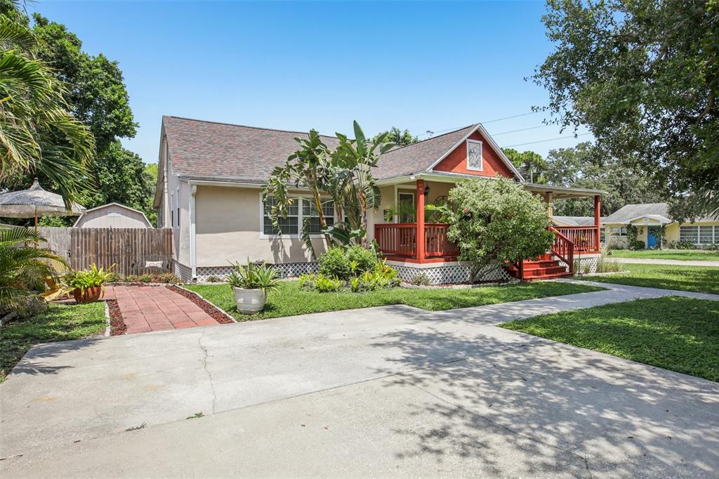 A single-story house with a red porch, tan siding, and a concrete driveway — 501 32ND AVENUE N, ST PETERSBURG, FL