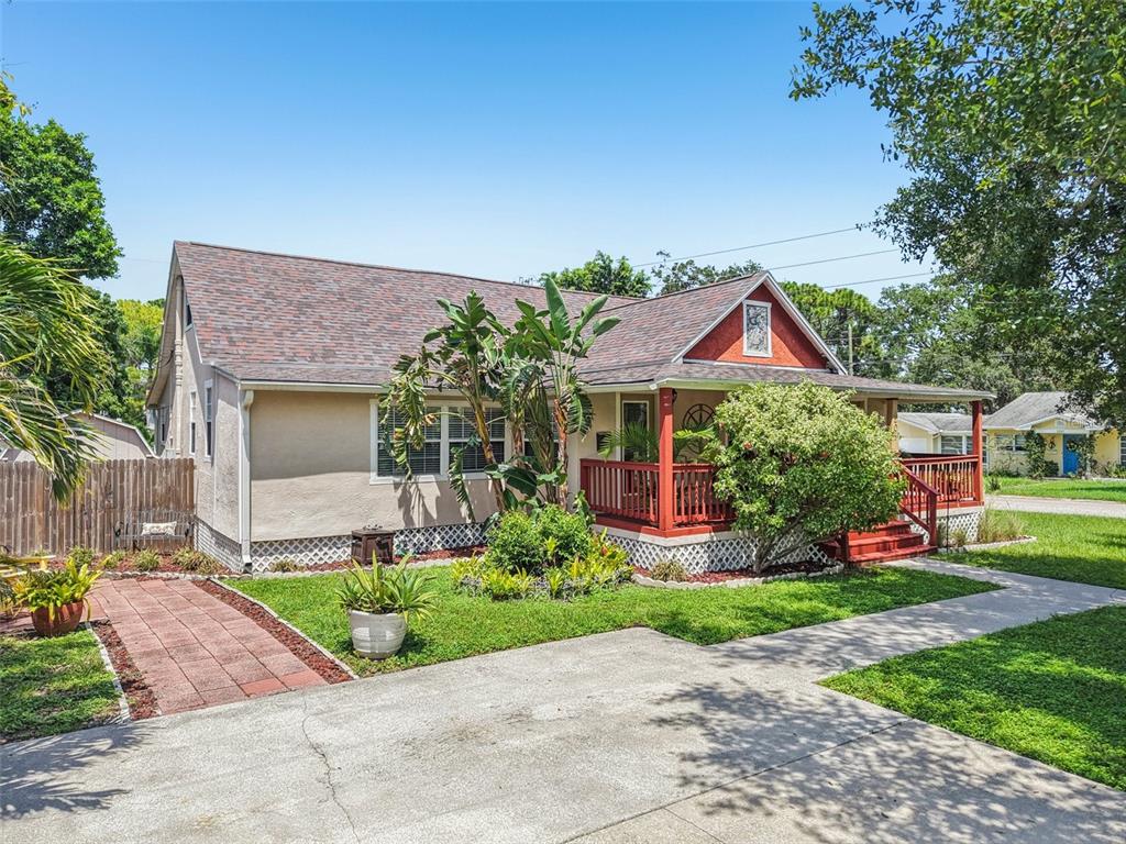 A single-story house with a red porch, tan stucco exterior, and a paved walkway — 501 32ND AVENUE N, ST PETERSBURG, FL