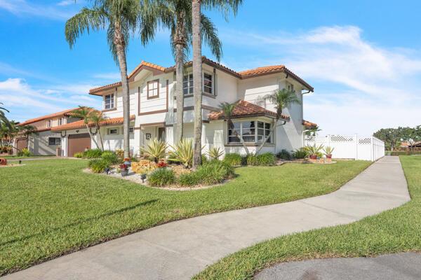 A two-story house with a white stucco exterior, tile roof, and palm trees in front — 6431 Olde Moat Way, Davie FL 33331, DAVIE, FL