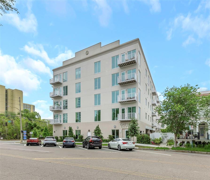 A multi-story apartment building with balconies and a parking lot in front — 600 3RD AVENUE S UNIT 305, ST PETERSBURG, FL