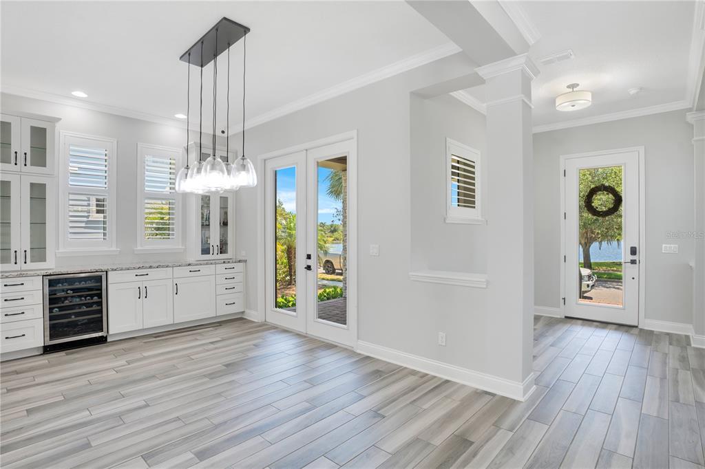 An empty room with light gray walls, wood-look tile flooring, and white plantation shutters — 13101 GABOR AVENUE, ORLANDO, FL