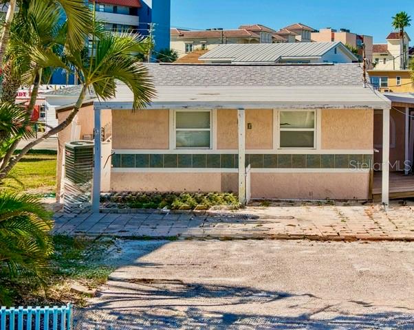 A single-story, light-colored house with a covered porch and a paved driveway — 50 137TH AVENUE CIRCLE, MADEIRA BEACH, FL
