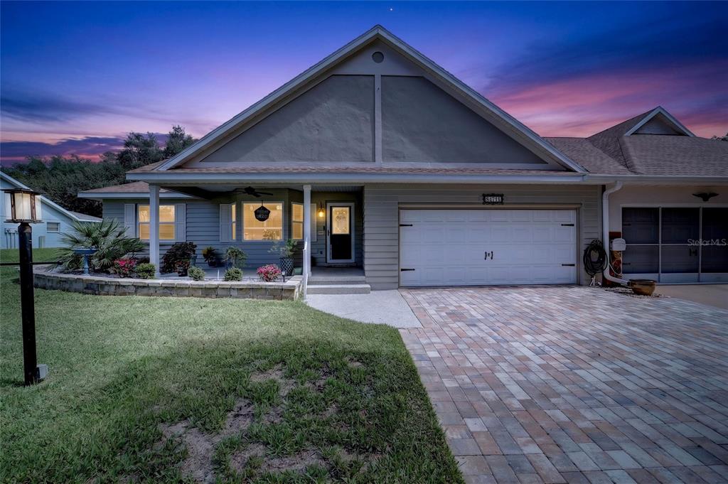 A single-story house features a paved driveway, a two-car garage, and a landscaped front yard — 8471 SW 91ST STREET UNIT A, OCALA, FL
